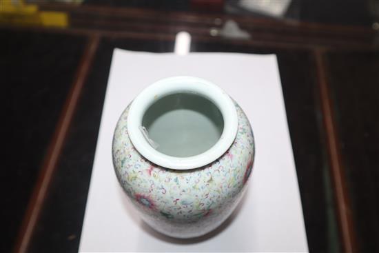 A Chinese famille rose ovoid vase, Qing dynasty, finely painted with flowers and scrolling foliage, H. 15cm, drilled hole to side of ba